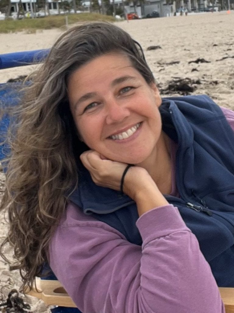 Bright smiling woman at the beach, Margaret Gartlguber enjoying seaside relaxation and sunshine.